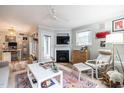 Sun-lit living room with fireplace, ceiling fan and adjacent work space at 1111 Parkridge Ln # 103, Raleigh, NC 27605