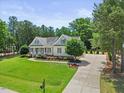 Expansive property showcasing a well-manicured lawn, elongated driveway, and beautiful landscaping at 113 Cedardale Ct, Clayton, NC 27520