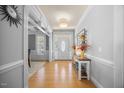 Elegant foyer featuring hardwood floors, sophisticated trim, and decorative console table at 113 Cedardale Ct, Clayton, NC 27520