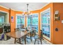 Bright breakfast nook featuring large windows, a chandelier and wood dining table at 115 Redbay Ln, Clayton, NC 27527