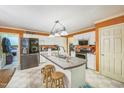 Functional kitchen with white cabinetry, central island with sink and seating, plus stainless steel appliances at 115 Redbay Ln, Clayton, NC 27527