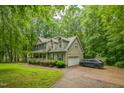 Lovely home showcasing a paved driveway, attached garage, and verdant lawn at 115 Redbay Ln, Clayton, NC 27527