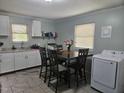 Bright dining area combined with laundry features a table for four and natural light perfect for mealtime and chores at 118 Lynn Rd, Durham, NC 27703