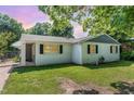 Charming single-story home featuring a classic white brick exterior and well-maintained lawn at 118 Lynn Rd, Durham, NC 27703