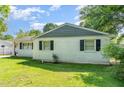 Charming single-story home featuring a classic white brick exterior and well-maintained lawn at 118 Lynn Rd, Durham, NC 27703