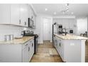 Well-equipped kitchen with an island featuring stone countertops and modern stainless appliances at 1213 Grenshaw Dr, Morrisville, NC 27560