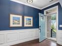 Inviting foyer featuring blue walls, white trim, and elegant decor at 136 Shadow Hawk Dr, Durham, NC 27713