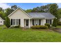 Charming single-story home with light siding, black shutters, and a well-maintained lawn at 139 Carriage Hill Dr, Stem, NC 27581