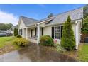 Well-maintained single-story home with a covered porch and manicured landscaping at 139 Carriage Hill Dr, Stem, NC 27581