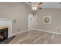 Inviting living room with a fireplace, vaulted ceiling, and wood-look flooring at 139 Carriage Hill Dr, Stem, NC 27581