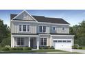 Charming two-story home with neutral siding, a covered porch, attached garage, and well-maintained landscaping at 1637 Goldfinch Perch Ln, Knightdale, NC 27545