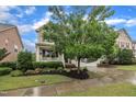 Beautiful home exterior boasting a lush lawn, attractive landscaping, and a welcoming covered front porch at 1920 Bright Kannon Way, Wendell, NC 27591