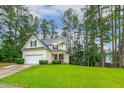 Charming home with manicured front lawn and mature trees, providing a serene setting at 1984 Sadler Ave, Creedmoor, NC 27522