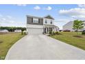 Charming two-story home with a manicured lawn, attached garage and welcoming front porch at 200 Gill Farm Way, Franklinton, NC 27525