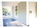 Covered porch with painted wood flooring and craftsman style rails and posts at 208 Glenn St, Franklinton, NC 27525
