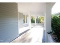 A view of the long porch with a painted wood floor and ceiling at 208 Glenn St, Franklinton, NC 27525
