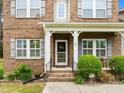 Close-up of the front door with brick steps and a 'Welcome' wreath at 21 Botanical Way, Pittsboro, NC 27312