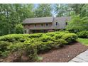 Brick home with manicured shrubs, showcasing the home's elegant architecture at 2300 Valley Forge Dr, Raleigh, NC 27615