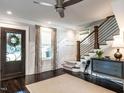 Elegant foyer featuring dark wood floors, staircase, and decorative details at 2303 Byrd St, Raleigh, NC 27608