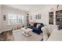 Bright office space with a comfortable blue couch, bookshelves, and natural light at 2636 Nordmann Fir Rd, Raleigh, NC 27616