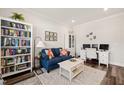 Cozy home office with built-in shelving, comfortable seating, and a functional desk area at 2636 Nordmann Fir Rd, Raleigh, NC 27616