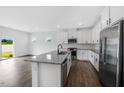 Bright kitchen featuring stainless steel appliances, granite countertops, and an island at 269 Hank Way, Angier, NC 27501