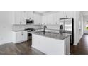 Modern kitchen featuring stainless steel appliances, granite countertops, and a stylish island at 269 Hank Way, Angier, NC 27501