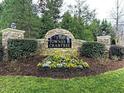 Stone community sign for The Townes at Crabtree, surrounded by lush landscaping and greenery at 2744 Laurelcherry St, Raleigh, NC 27612