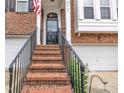 Front entrance featuring brick steps with an iron railing leading to the front door at 2744 Laurelcherry St, Raleigh, NC 27612