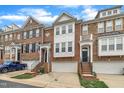 A row of brick townhomes with garages, entry stairs, and detailed architectural features at 2744 Laurelcherry St, Raleigh, NC 27612