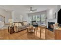 Bright living room features hardwood floors, a cozy fireplace, and large windows at 2744 Laurelcherry St, Raleigh, NC 27612