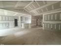 Open-concept living area with high ceilings, neutral walls, and access to multiple rooms at 2744 Rains Mill Rd, Princeton, NC 27569