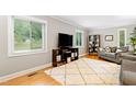 Bright living room with hardwood floors, neutral paint, and an oversized area rug at 2805 Friendship Rd, Durham, NC 27705