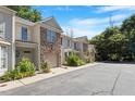 Street view of townhouses featuring well-maintained landscaping, garages, and sidewalks at 2822 Pickett Rd # 132, Durham, NC 27705