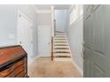 Inviting foyer with tiled floor, staircase, and elegant chest of drawers providing an airy welcome at 301 Presque Isle Ln, Chapel Hill, NC 27514