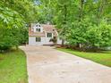 Beautiful home with a long driveway surrounded by lush greenery and mature trees at 310 Heidinger Dr, Cary, NC 27511