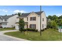 Inviting exterior of a two-story home with manicured landscaping and a view of the surrounding neighborhood at 3705 Rivermist Dr, Raleigh, NC 27610