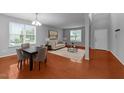 Spacious living room featuring hardwood floors and lots of natural light from large windows at 3705 Rivermist Dr, Raleigh, NC 27610