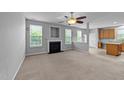 Spacious living room featuring a cozy fireplace, lots of natural light, and a seamless layout to the kitchen at 3705 Rivermist Dr, Raleigh, NC 27610