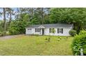 Charming one-story home features black shutters and a well-manicured lawn at 3803 Jonesville Rd, Wake Forest, NC 27587