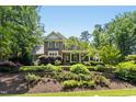 Beautiful exterior of a two-story brick home featuring a manicured front lawn and mature trees at 4021 Chaumont Dr, Apex, NC 27539