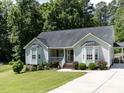Inviting single-story home with a well-kept lawn, bay windows, and a covered porch, with a driveway to the right at 4132 Battle Field Dr, Garner, NC 27529