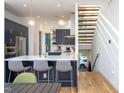 Stylish kitchen boasts navy cabinets, a spacious island with bar seating, and modern lighting fixtures at 414 Chavis Way, Raleigh, NC 27601