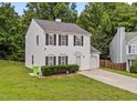 Traditional two-story home boasts an attached garage, green lawn, and classic black shutters at 4221 Ivy Hill Rd, Raleigh, NC 27616
