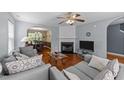 Inviting living room with hardwood floors, fireplace, and open view to the dining area at 4221 Ivy Hill Rd, Raleigh, NC 27616