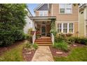 Charming two-story home featuring a welcoming front porch and beautifully landscaped front yard at 4409 All Points View Way, Raleigh, NC 27614