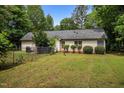 Fenced backyard featuring mature trees, level lawn, a garden, and a home with vinyl siding at 4508 Alice Dr, Oxford, NC 27565
