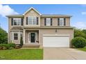 Inviting two-story home with a well-kept lawn, flower beds, and a spacious two-car garage at 50 Consella Way, Franklinton, NC 27525