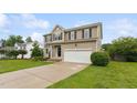 Two-story home with an attached garage, well-maintained lawn, and landscaping at 50 Consella Way, Franklinton, NC 27525