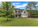 Traditional two-story home with a well-kept lawn and mature trees at 5025 Stonewood Pines Dr, Knightdale, NC 27545